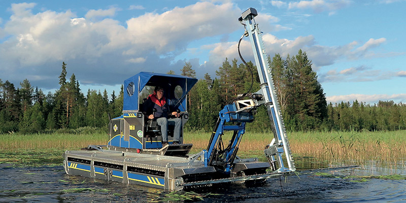 Truxor with Doro Cutter trimming tall aquatic vegetation in a shallow lake