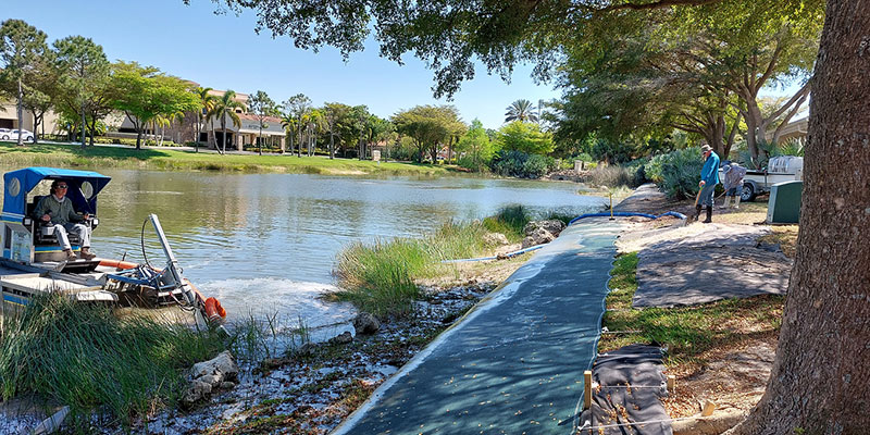 Truxor machine removing vegetation from a residential lake
